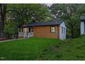 Charming cottage features a covered porch and horizontal wood siding with modern outdoor lighting at 805 Camden Ave, Durham, NC 27701