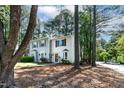 Exterior view of townhomes featuring well-manicured lawns and mature trees at 102 Rosebrooks Dr, Cary, NC 27513
