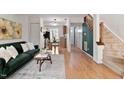 Inviting living room flows into a modern kitchen, featuring wood floors and a cozy atmosphere at 102 Rosebrooks Dr, Cary, NC 27513