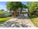Wide concrete driveway leading to the charming brick home with a spacious two-car garage at 104 Crossway Ln, Holly Springs, NC 27540