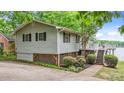 Well-maintained home featuring horizontal siding, large deck, and landscaped yard at 104 Pontiac Cv, Louisburg, NC 27549