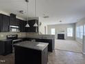 Stylish kitchen with stainless steel appliances, granite countertops, and dark cabinets at 105 Blue Bay Ln, Cameron, NC 28326