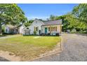 Charming single-story home with a well-manicured lawn, beautiful shutters, and a welcoming front porch at 105 N 11Th St, Erwin, NC 28339