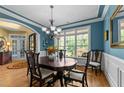 Bright dining area featuring a round table, chandelier, large window, and colorful decor, perfect for Gathering gatherings at 110 Pebble Creek Dr, Franklinton, NC 27525