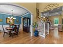 Elegant dining room with hardwood floors, chandelier, and a built-in cabinet, flowing into a living area with a fireplace at 110 Pebble Creek Dr, Franklinton, NC 27525