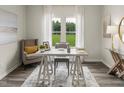 Bright home office featuring a modern desk, comfortable seating, and a large window with green view at 1100 Landen Creek Ln, Zebulon, NC 27597