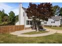 Landscaped yard and manicured lawn surround this charming home with green shutters at 1114 Balmoral Dr, Cary, NC 27511