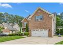 Two-story brick home with well-maintained lawn and an attached two-car garage at 114 Bell Tower Ct, Elon, NC 27244