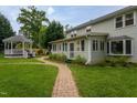 Well-maintained backyard featuring a gazebo and a winding brick path through the green grass at 1213 Indian Trail Dr, Raleigh, NC 27609