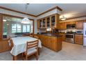 Traditional kitchen with oak cabinets, stainless steel appliances, and an adjacent dining area at 1213 Indian Trail Dr, Raleigh, NC 27609