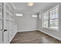 Home office offers built-in shelving, large windows and hardwood floors at 127 Post Oak Rd, Chapel Hill, NC 27516