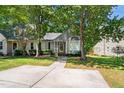 Charming home with mature trees, a bay window, and an inviting walkway at 140 Heatherwood Dr, Apex, NC 27502