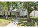 Inviting home featuring manicured landscaping, a bay window, and a charming entrance at 140 Heatherwood Dr, Apex, NC 27502