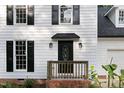Close up of front door with a small porch and updated front door with sidelights at 1609 Falls Ct, Raleigh, NC 27615