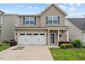 Charming two-story home with a well-manicured lawn and a two-car garage, perfect for families at 1839 Huntley Way, Burlington, NC 27215