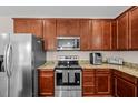 Modern kitchen featuring stainless steel appliances, granite countertops, and stylish wood cabinetry at 1839 Huntley Way, Burlington, NC 27215