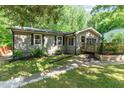 Cozy single story house featuring neutral siding, black shutters, and well-manicured front yard with green grass at 2029 Atkins Dr, Raleigh, NC 27610