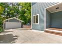 Backyard view featuring a detached garage and spacious concrete area, perfect for parking at 2517 Medway Dr, Raleigh, NC 27608