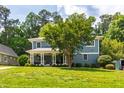 Beautiful two-story home with a spacious yard, inviting front porch, and mature trees at 2517 Medway Dr, Raleigh, NC 27608