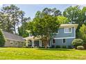 Attractive two-story home with a classic front porch, complemented by a well-maintained lawn and lush greenery at 2517 Medway Dr, Raleigh, NC 27608