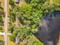Overhead view of a house nestled among green trees, adjacent to a serene lake at 2608 Knightwood Rd, Fuquay Varina, NC 27526