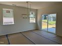 Light-filled dining room with modern chandelier and sliding glass doors to the backyard at 2628 Pivot Ridge Dr, Raleigh, NC 27616