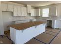 Bright kitchen featuring white cabinets, subway tile backsplash, and a large center island at 2628 Pivot Ridge Dr, Raleigh, NC 27616