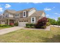 Attractive home exterior with lush green lawn, colorful flowers, and a two-car garage at 2737 Casper Creek Ln, Raleigh, NC 27616