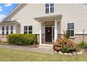 Inviting entrance to this home features a lovely front door framed by lush landscaping at 2737 Casper Creek Ln, Raleigh, NC 27616