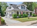 Beautiful two-story home with a covered porch, flagpole, and well-maintained landscaping at 310 Henderson St, Oxford, NC 27565