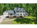 Attractive two-story home with a lush lawn, manicured landscaping, and an attached two car garage at 318 Hepowil Trce, Hillsborough, NC 27278