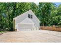 Spacious two-car garage with a full-height ceiling and wide driveway, providing ample parking space at 318 Hepowil Trce, Hillsborough, NC 27278
