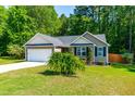 Charming single-story home with a two-car garage and landscaped front yard at 33 Carrington Cir, Angier, NC 27501