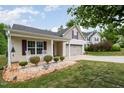 Exterior view of a charming home with a well-maintained lawn and inviting curb appeal at 334 Huckleberry Loop, Mebane, NC 27302