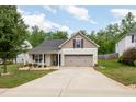 Charming home with a well-manicured lawn, two-car garage, and inviting curb appeal at 334 Huckleberry Loop, Mebane, NC 27302