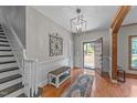 Inviting foyer with hardwood floors, staircase, and stylish light fixture at 409 W Holding St, Smithfield, NC 27577
