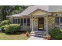 Close-up view of the home's stone front entrance with covered porch and flower pots at 409 W Holding St, Smithfield, NC 27577