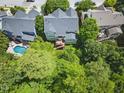 Aerial view of the home, deck, pool, and lush greenery at 415 Waverly Hills Dr, Cary, NC 27519