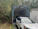 Large carport on the property featuring a full-size car and a pickup truck at 420 Spring Ln, Henderson, NC 27537