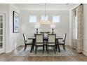 Elegant dining room featuring modern chandelier lighting and stylish wainscoting at 445 Olivia Crossing Ct # 22, Four Oaks, NC 27524