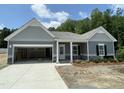 Charming single-story home with stone accents, attached garage, and covered front porch at 445 Olivia Crossing Ct # 22, Four Oaks, NC 27524