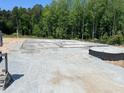 New home concrete slab foundation ready for construction with the plumbing visible at 445 Olivia Crossing Ct # 22, Four Oaks, NC 27524