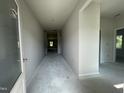 Bright hallway with neutral paint; ready for personalization and leading to various rooms at 445 Olivia Crossing Ct # 22, Four Oaks, NC 27524