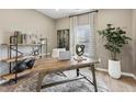 Inviting home office with a rustic wood desk, modern shelving, and large window at 445 Olivia Crossing Ct # 22, Four Oaks, NC 27524