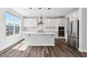 Beautiful kitchen featuring a stainless steel refrigerator, a kitchen island, and subway tile backsplash with lots of light at 46 Waterfall Pointe, Chapel Hill, NC 27517