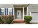 Inviting front entry showcasing a white front door, brick steps, and well-maintained landscaping at 468 Hay River St, Garner, NC 27529