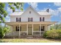 Exterior front porch showcasing white railing, columns, and a swing for relaxing outdoors at 5062 Dorsey Rd, Oxford, NC 27565
