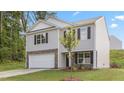 Inviting two-story home showcasing stone details and a well-manicured lawn at 522 Lochalsh Dr, Gibsonville, NC 27249