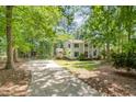 Inviting two-story home featuring traditional design, surrounded by mature trees, set back on private lot at 5312 Hallmark Rd, Durham, NC 27712