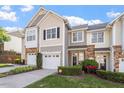 Townhome featuring an attached garage and professional landscaping in a vibrant community at 5912 Hourglass Ct, Raleigh, NC 27612